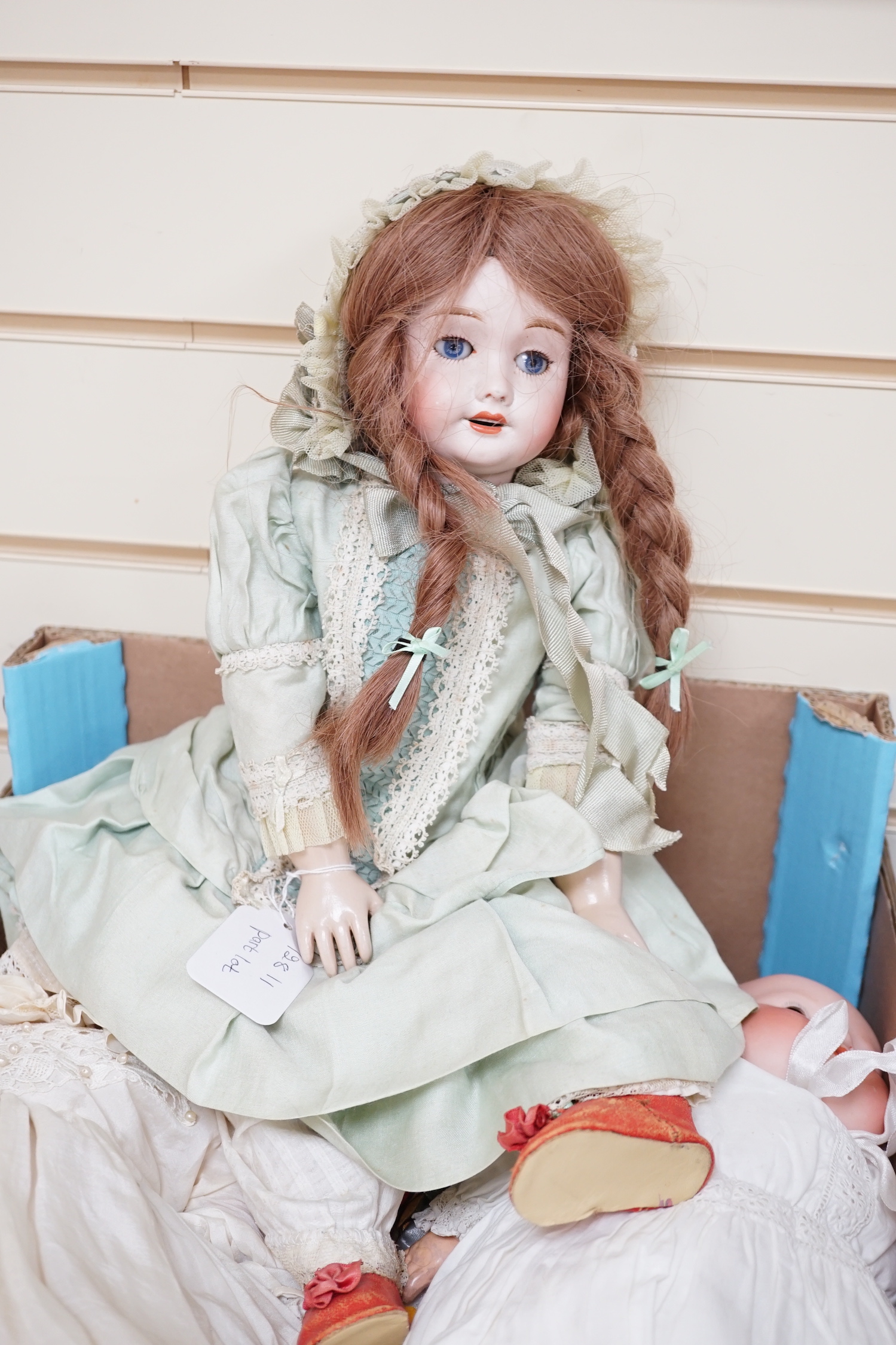 A German bent limb doll, height 63cm, hands damaged, vintage clothes, Cherie French doll's head on replaced new body, two hard plastic dolls, one Pedigree AM Dream Baby doll, soft body, small hard plastic baby in crib